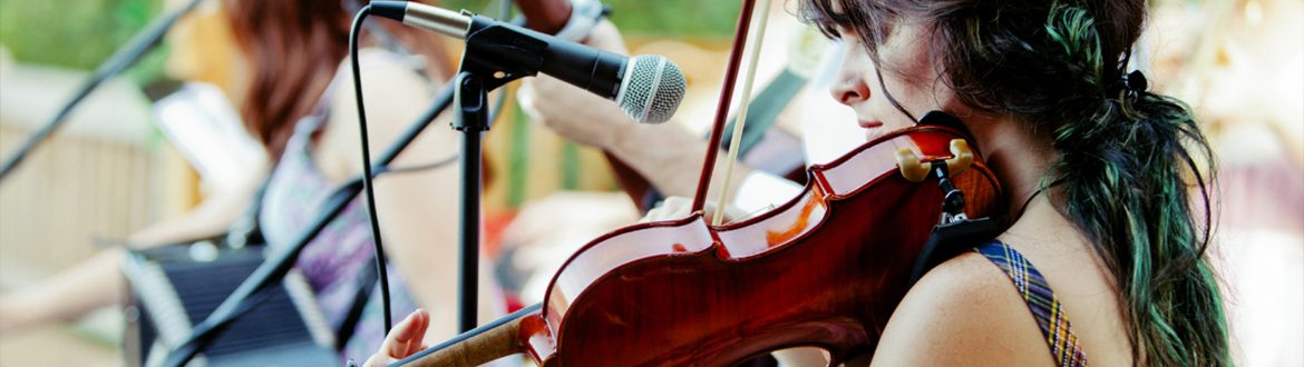 Woman practicing violin on stage